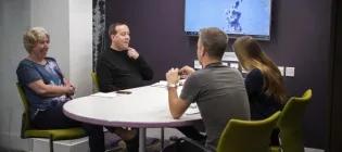 A group of people in the meeting pod